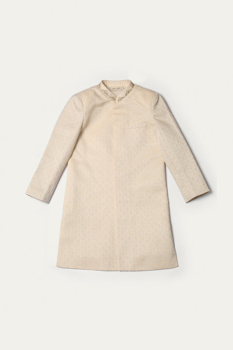 Boys Cream Karandi Sherwani with white trouser.